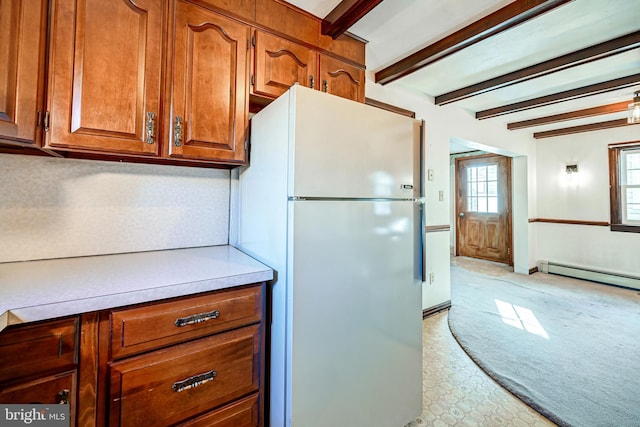 kitchen featuring beam ceiling, a baseboard radiator, and white refrigerator