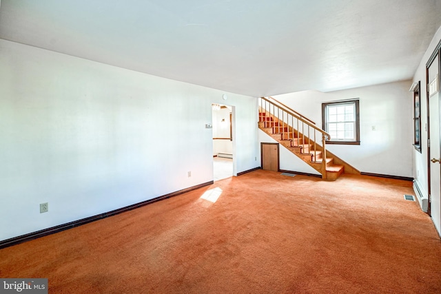 unfurnished living room featuring carpet and a baseboard heating unit