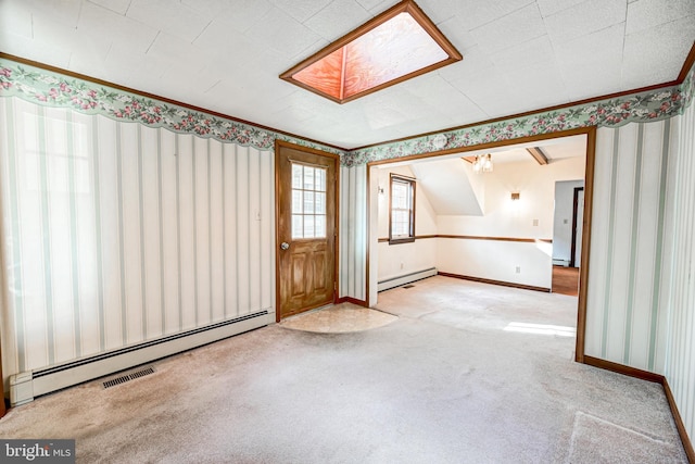 carpeted spare room with a skylight and a baseboard radiator