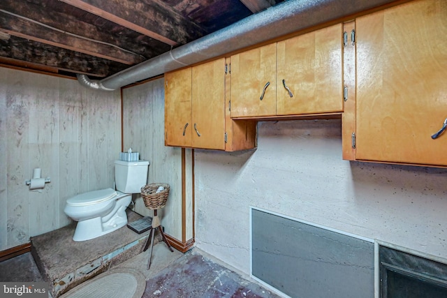 interior space with concrete flooring and toilet