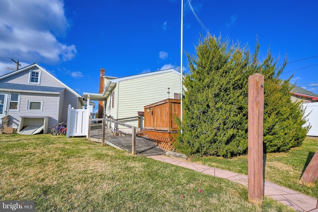 rear view of house featuring a yard