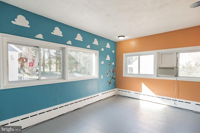 unfurnished room with a textured ceiling and a baseboard radiator