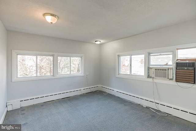 carpeted empty room featuring a textured ceiling, a baseboard radiator, a wealth of natural light, and cooling unit