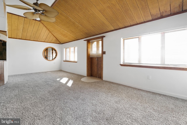 carpeted spare room with wooden ceiling, vaulted ceiling, baseboards, and ceiling fan