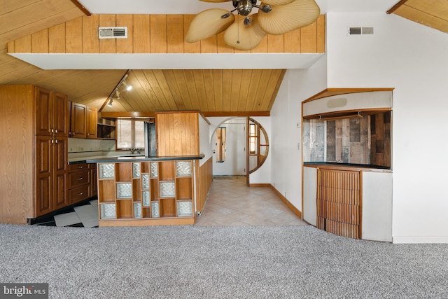 kitchen featuring vaulted ceiling, ceiling fan, wooden ceiling, and visible vents