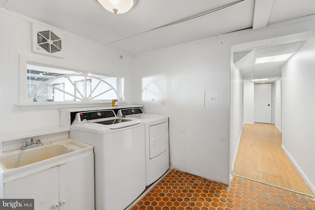 laundry room with wood-type flooring and washing machine and clothes dryer