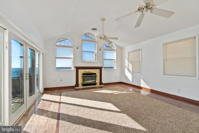 unfurnished living room with french doors, dark hardwood / wood-style floors, vaulted ceiling, and ceiling fan