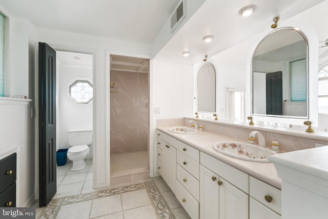 bathroom with double vanity, tile patterned flooring, a sink, and visible vents