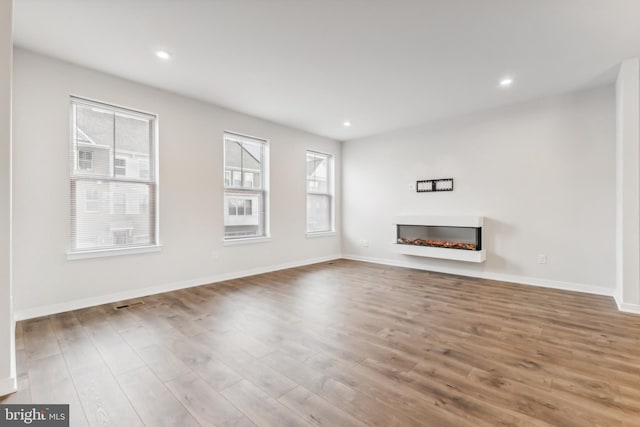 unfurnished living room featuring wood-type flooring