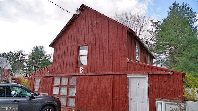 view of side of home featuring an outbuilding