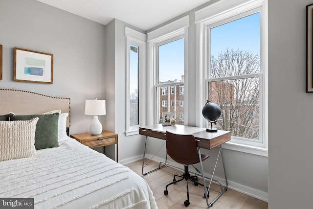 bedroom featuring light hardwood / wood-style floors and multiple windows