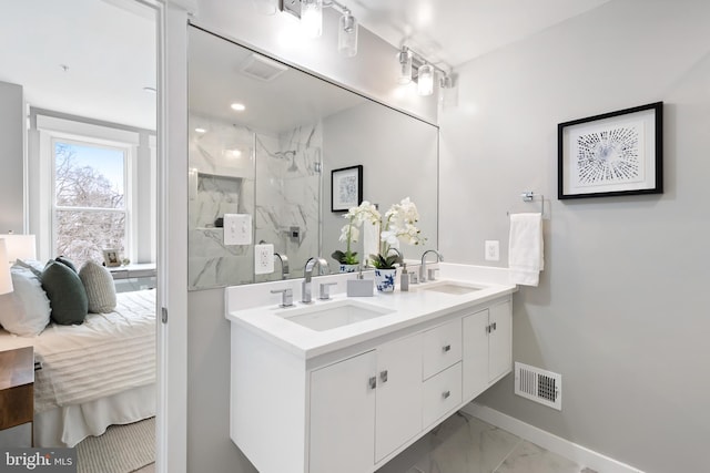 bathroom featuring vanity and tiled shower