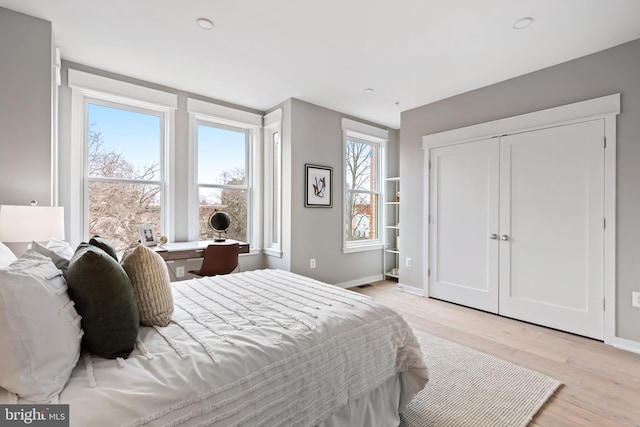 bedroom featuring light hardwood / wood-style floors and a closet