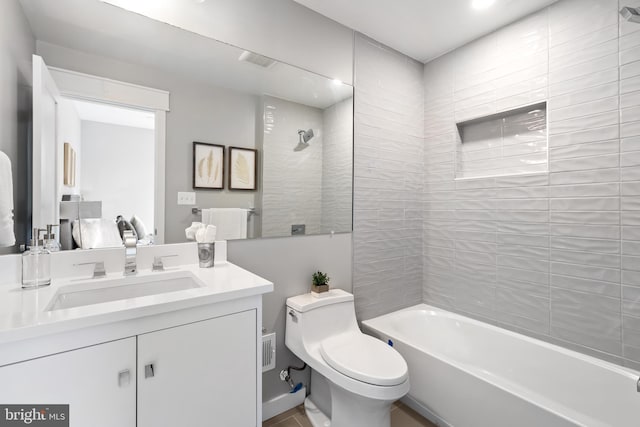 full bathroom with vanity, toilet, and tiled shower / bath combo