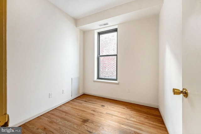 unfurnished room with light wood-type flooring