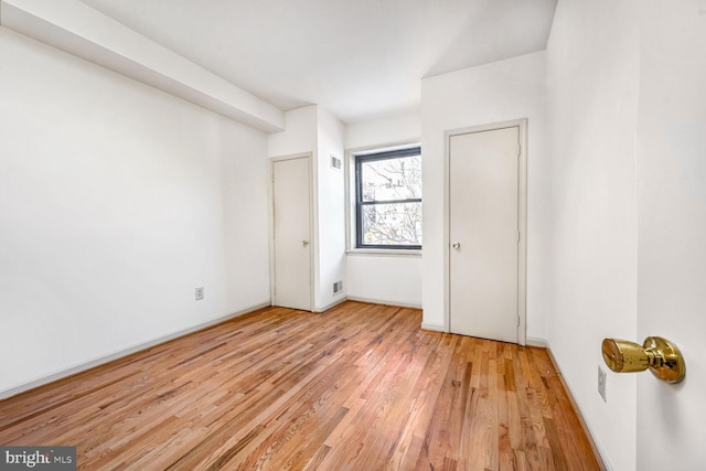 spare room with light hardwood / wood-style flooring