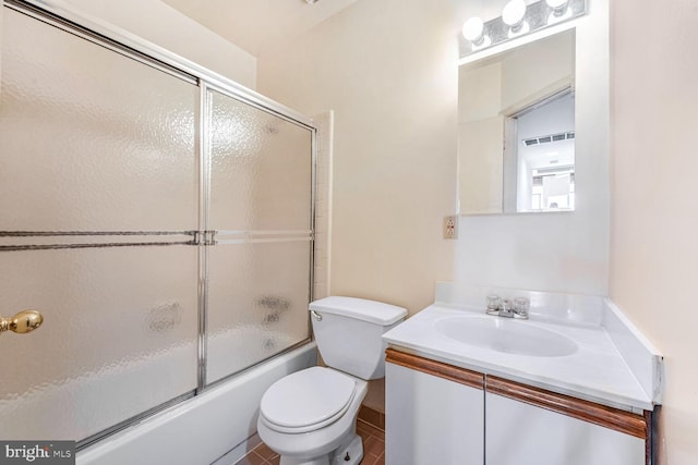 full bathroom with tile patterned flooring, vanity, toilet, and combined bath / shower with glass door