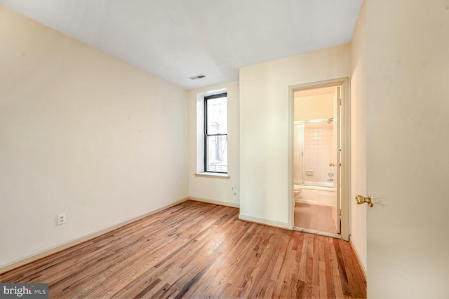 unfurnished room with light wood-type flooring