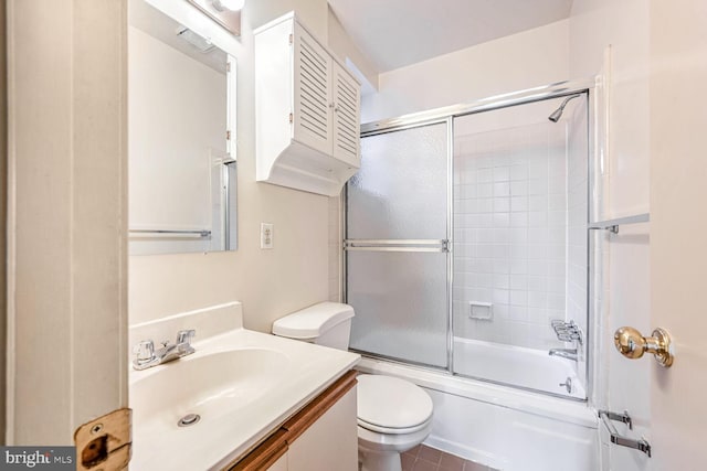 full bathroom with tile patterned flooring, vanity, toilet, and shower / bath combination with glass door