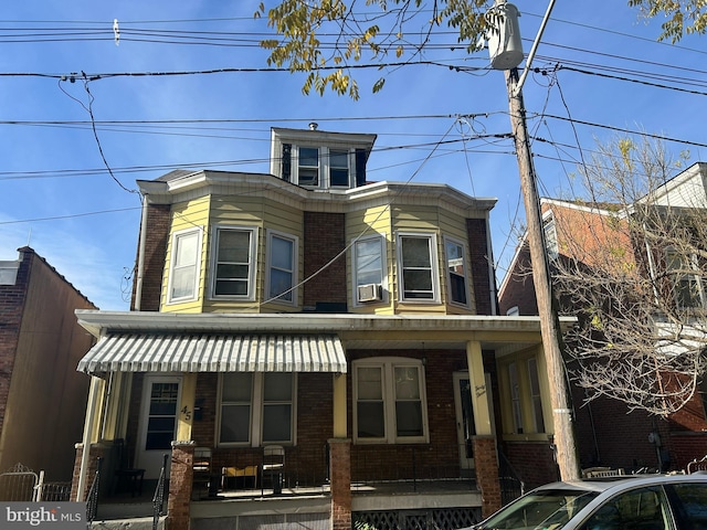 view of front facade with a porch and cooling unit