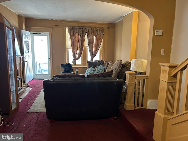 carpeted living room featuring crown molding