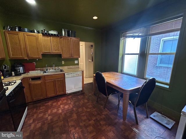 kitchen featuring dark parquet flooring, sink, white appliances, and ornamental molding