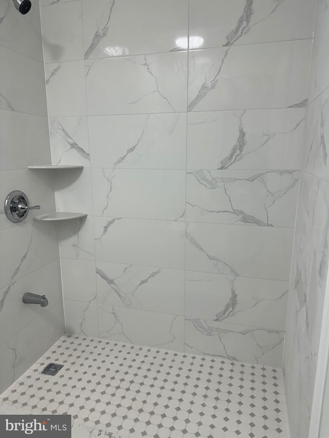 bathroom with tiled shower