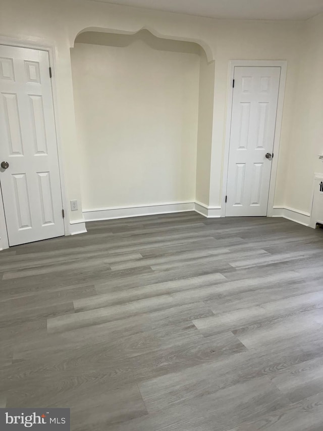 unfurnished room with hardwood / wood-style flooring