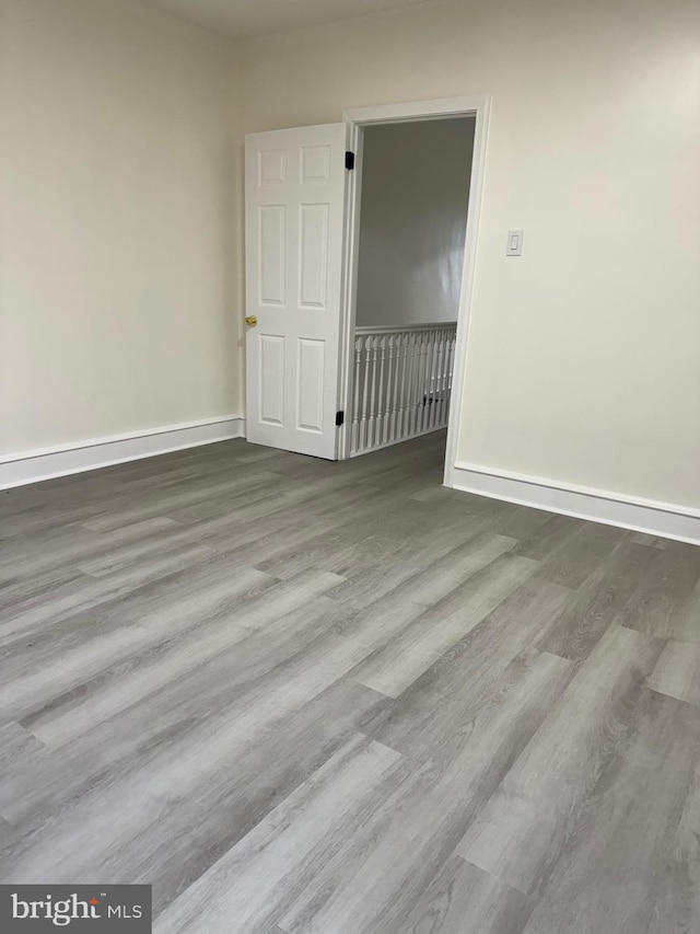 unfurnished room featuring hardwood / wood-style floors