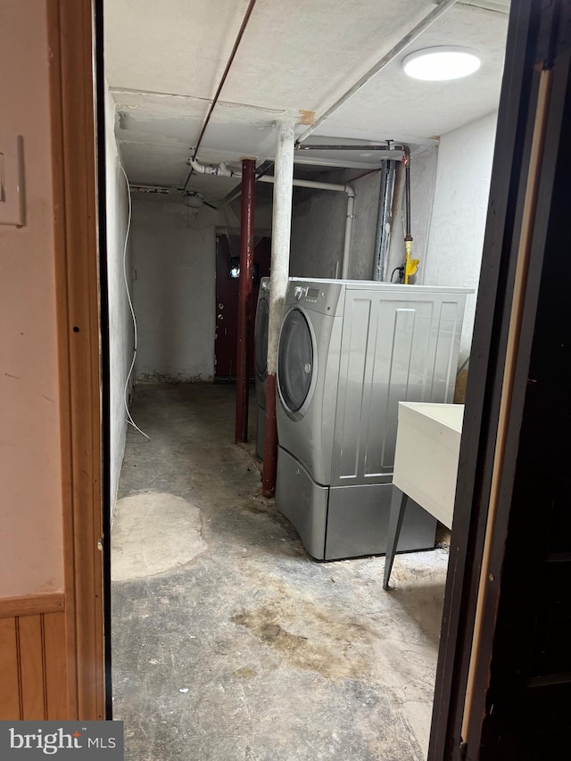 washroom with independent washer and dryer and sink