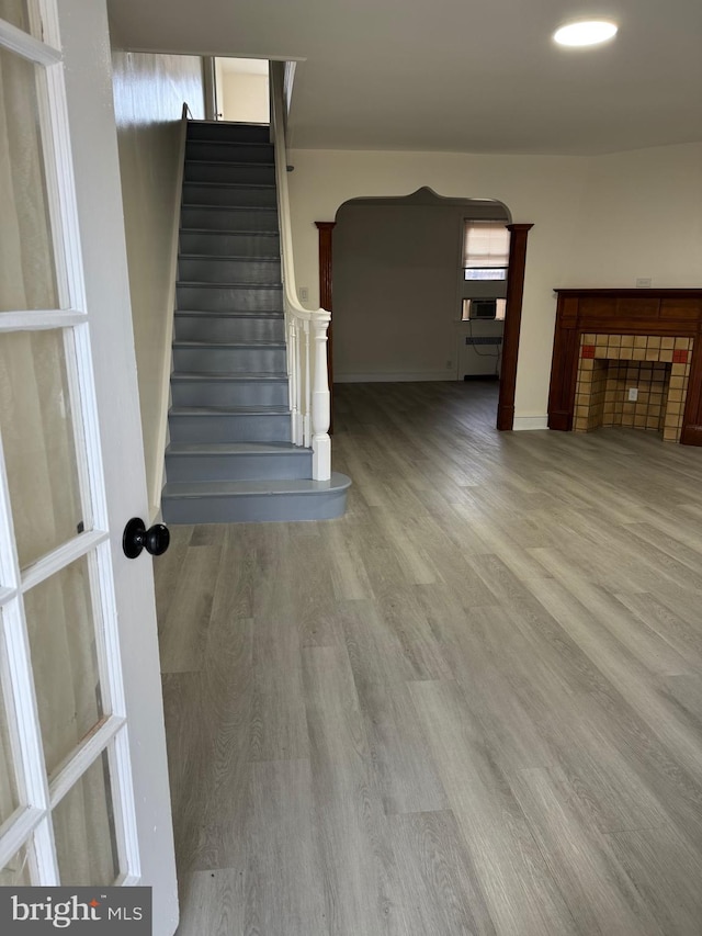 stairs featuring a fireplace and hardwood / wood-style floors