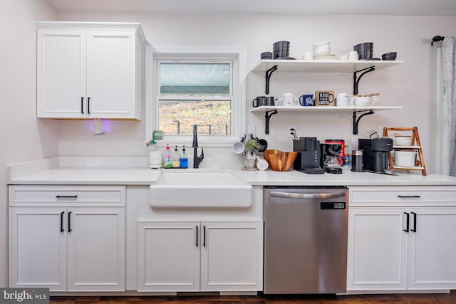 kitchen with dishwasher, white cabinetry, and sink