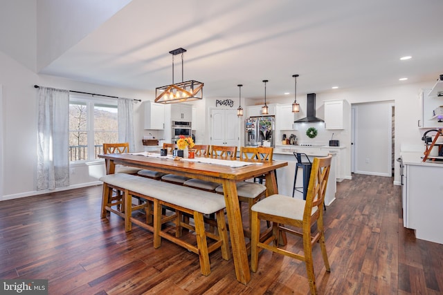 dining space with dark hardwood / wood-style flooring and sink