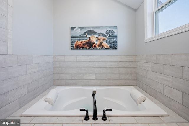 bathroom with tiled tub