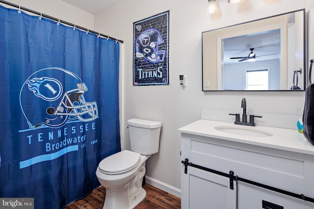 bathroom featuring curtained shower, ceiling fan, wood-type flooring, toilet, and vanity