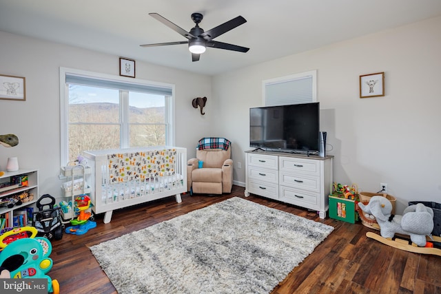 recreation room with ceiling fan and dark hardwood / wood-style flooring