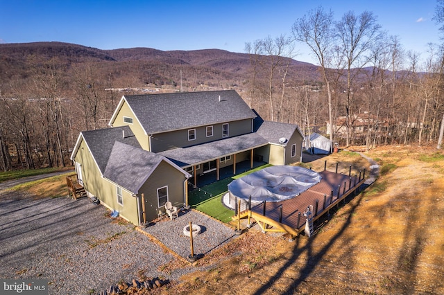 birds eye view of property with a mountain view