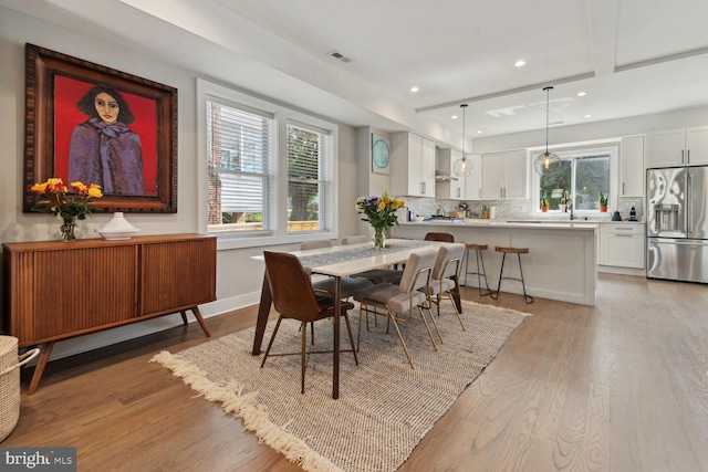 dining area featuring a healthy amount of sunlight and light wood-type flooring