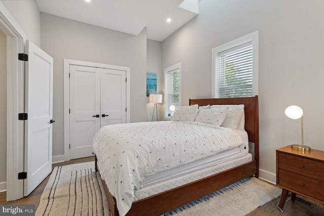 bedroom with wood-type flooring and a closet