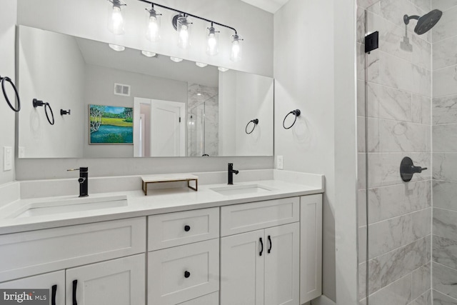 bathroom with vanity and a tile shower