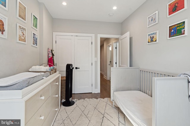 bedroom with light wood-type flooring and a closet