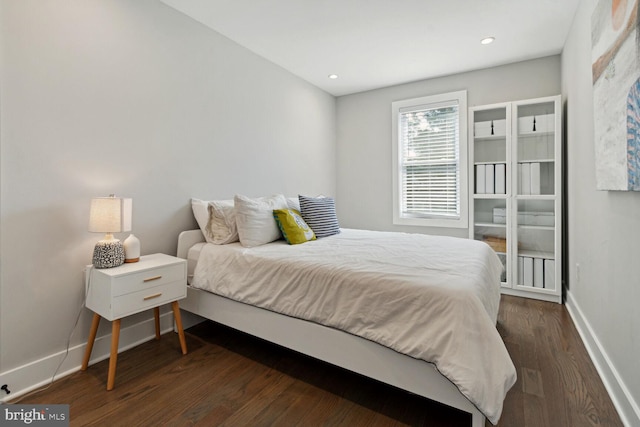 bedroom featuring dark hardwood / wood-style flooring