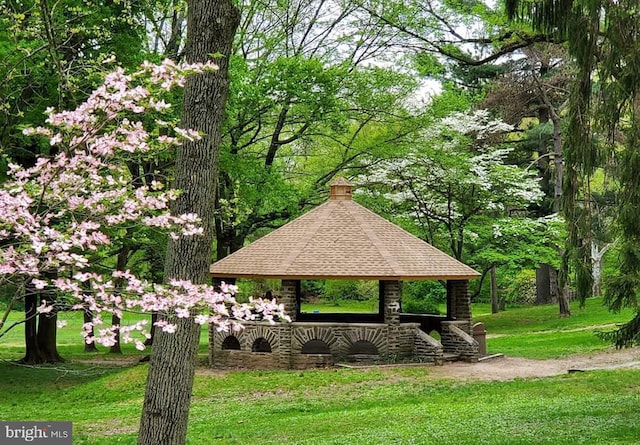 view of property's community with a gazebo and a yard