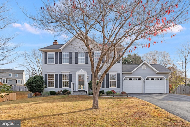 view of front of property with a front lawn and a garage