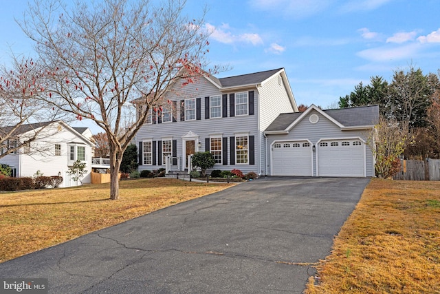 view of front facade featuring a front yard and a garage