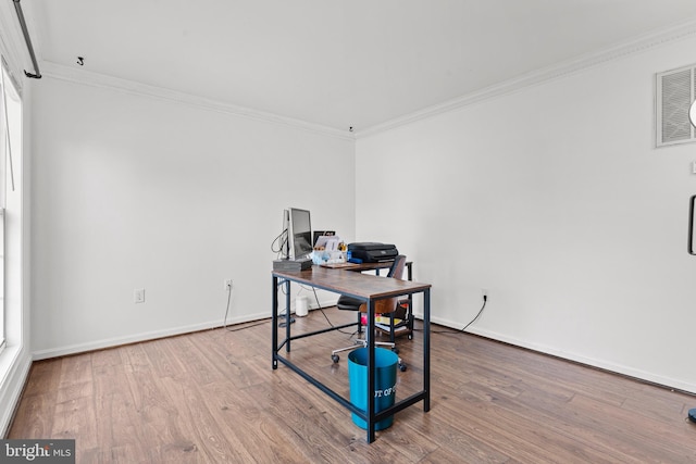 home office with wood-type flooring and ornamental molding