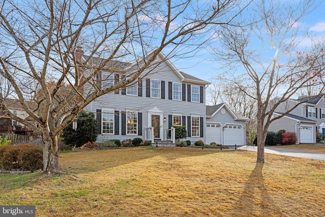 view of front of house featuring a front yard and a garage