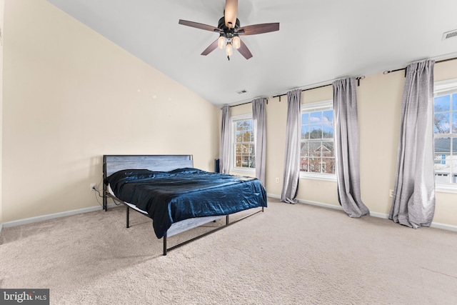 bedroom with ceiling fan, lofted ceiling, and carpet floors