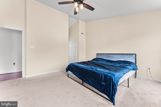 bedroom featuring carpet flooring, a closet, high vaulted ceiling, and ceiling fan