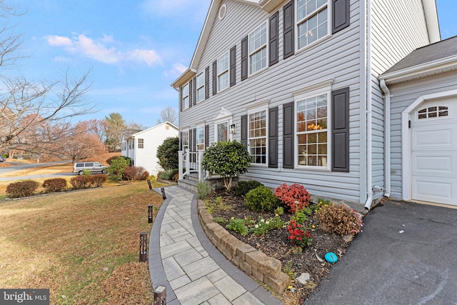 exterior space with a yard and a garage